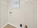 Bright laundry room with a window, wire shelves, and plumbing fixtures for washer and dryer hookups at 1760 Mountclair Ct, Mount Dora, FL 32757