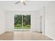 Spacious living room featuring plank flooring and sliding glass doors to the backyard at 1760 Mountclair Ct, Mount Dora, FL 32757