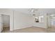 Open living area with an adjoining kitchen featuring light, neutral paint, and hard surface floors at 1760 Mountclair Ct, Mount Dora, FL 32757