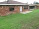 A well-maintained backyard features a brick exterior and lush green lawn at 661 Lake Carolyn Cir, Lakeland, FL 33813