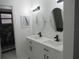 Contemporary bathroom featuring dual sinks, sleek vanity, and a tiled shower with glass door at 661 Lake Carolyn Cir, Lakeland, FL 33813