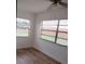 A naturally lit bedroom features modern ceiling fan and sleek, wood-look laminate flooring at 661 Lake Carolyn Cir, Lakeland, FL 33813