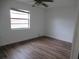 Comfortable bedroom with light-colored walls, wood-look floors and a bright window at 661 Lake Carolyn Cir, Lakeland, FL 33813