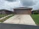 Cozy single-story home featuring brick facade, attached garage, and a convenient driveway at 661 Lake Carolyn Cir, Lakeland, FL 33813