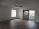 Bright, airy living room with new flooring, ceiling fan and sliding glass doors to the porch at 661 Lake Carolyn Cir, Lakeland, FL 33813