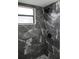 Upgraded bathroom with a modern shower featuring stylish marble-look tile and rainfall showerhead at 661 Lake Carolyn Cir, Lakeland, FL 33813