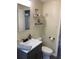 Well-lit bathroom with modern fixtures, stylish vanity, and decorative shelving at 309 Sunnyside Ln, Debary, FL 32713