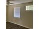 Bedroom featuring light walls, wood-look laminate flooring, and a glass block window at 309 Sunnyside Ln, Debary, FL 32713
