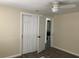 Bedroom with closet leading to on-suite bathroom; light walls and wood-look laminate flooring at 309 Sunnyside Ln, Debary, FL 32713