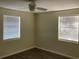 Bedroom with wood-look laminate flooring, light colored walls, a ceiling fan, and natural light at 309 Sunnyside Ln, Debary, FL 32713
