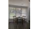 Eat-in kitchen area with a glass table and two chairs; natural light provided by a large window at 309 Sunnyside Ln, Debary, FL 32713