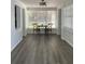Spacious dining area featuring wood-look flooring, neutral walls, and many windows that let in a lot of light at 309 Sunnyside Ln, Debary, FL 32713