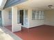 Covered front porch with brick accents and decorative wreath on the front door at 309 Sunnyside Ln, Debary, FL 32713
