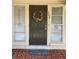Inviting front entrance featuring a decorative wreath, house number and 'Welcome' doormat at 309 Sunnyside Ln, Debary, FL 32713