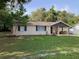 Cozy home with brick exterior, black shutters, and well-kept lawn at 309 Sunnyside Ln, Debary, FL 32713