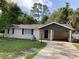 Charming single story home with a well-manicured lawn and covered carport at 309 Sunnyside Ln, Debary, FL 32713