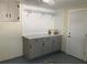 Functional laundry room with ample counter space, storage cabinets, and shelving at 309 Sunnyside Ln, Debary, FL 32713