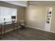 Neutral living room with light walls, a built-in bookcase, and dark wood-look laminate flooring at 309 Sunnyside Ln, Debary, FL 32713