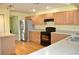 Well-lit kitchen with wood floors, modern appliances, and a functional layout at 3629 Welsh Way, Lakeland, FL 33813