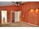 Cozy main bedroom featuring decorative wall accents, ceiling fan, and en-suite bathroom at 3629 Welsh Way, Lakeland, FL 33813