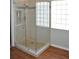 Walk-in shower featuring glass door, niche, shower head, and tile flooring at 3629 Welsh Way, Lakeland, FL 33813