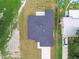 An aerial view showcases a home's gray roof and well-kept surroundings in a suburban setting at 4189 Homestead Dr, Lakeland, FL 33810