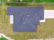 Birds eye view of a home displaying a sleek gray roof against a backdrop of manicured green lawn and a paved driveway at 4189 Homestead Dr, Lakeland, FL 33810