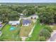 An aerial view offers a glimpse of the home's layout, yard, and neighboring houses in a quiet community at 4189 Homestead Dr, Lakeland, FL 33810