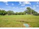 Generous backyard space with mature trees and level ground offering various possibilities at 4189 Homestead Dr, Lakeland, FL 33810