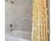 Tiled shower and tub combination with a decorative shower curtain at 4189 Homestead Dr, Lakeland, FL 33810