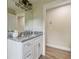 Bathroom featuring granite countertops, a modern vanity, and wood-look flooring at 4189 Homestead Dr, Lakeland, FL 33810