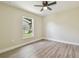 Bright bedroom with a ceiling fan, new vinyl plank flooring, and a view of the backyard at 4189 Homestead Dr, Lakeland, FL 33810