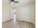 Spacious bedroom with new flooring, a ceiling fan, and ample closet space with folding doors at 4189 Homestead Dr, Lakeland, FL 33810