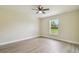 Bedroom with wood-look flooring and a window overlooking the yard at 4189 Homestead Dr, Lakeland, FL 33810