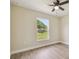 Bedroom featuring wood-look floors, a ceiling fan, and a window overlooking the yard at 4189 Homestead Dr, Lakeland, FL 33810
