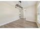 Open dining space with stylish light fixture and wood-look floors, seamlessly connected to other rooms at 4189 Homestead Dr, Lakeland, FL 33810