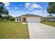 Beautifully landscaped single-Gathering home featuring a two-car garage and freshly cut lawn at 4189 Homestead Dr, Lakeland, FL 33810