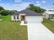 A view of the home's front exterior highlighting the attached garage and well-maintained landscaping at 4189 Homestead Dr, Lakeland, FL 33810