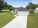 A view of the home's front exterior highlighting the attached garage and well-maintained landscaping at 4189 Homestead Dr, Lakeland, FL 33810