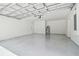 Spacious garage featuring epoxy flooring, white painted walls, and a modern, sectional garage door at 4189 Homestead Dr, Lakeland, FL 33810