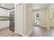 Bright hallway leads past a closet, showcasing the new luxury vinyl plank flooring and a view of the front door at 4189 Homestead Dr, Lakeland, FL 33810