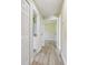 Hallway with wood-look flooring and access to a bathroom and bedroom at 4189 Homestead Dr, Lakeland, FL 33810