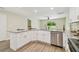 Renovated kitchen with stainless steel dishwasher, white cabinets, granite counters and backyard view at 4189 Homestead Dr, Lakeland, FL 33810
