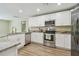 Modern kitchen boasts stainless steel appliances, granite countertops, and white shaker cabinets at 4189 Homestead Dr, Lakeland, FL 33810