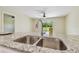 Close-up of a stainless steel kitchen sink with a modern faucet and granite countertops at 4189 Homestead Dr, Lakeland, FL 33810