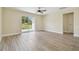 Living room featuring wood-look floors and sliding glass doors to the backyard at 4189 Homestead Dr, Lakeland, FL 33810