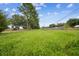 A view of the lot highlighting the ample green space and surrounding trees at 4189 Homestead Dr, Lakeland, FL 33810