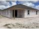 New construction home featuring a covered patio and builder paper on the exterior walls in backyard at 2244 Broadbrook Drive, St Cloud, FL 34771