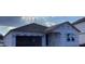 Exterior view of a new construction home with siding, a dark shingled roof and an attached two car garage at 2244 Broadbrook Drive, St Cloud, FL 34771