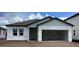 New construction home featuring a garage, double windows, and light gray siding at 2373 Broadbrook Drive, St Cloud, FL 34771
